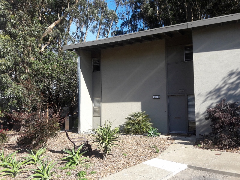 a side view of a building with a blue door