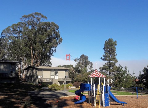 a playground with a view of the golden gate bridge