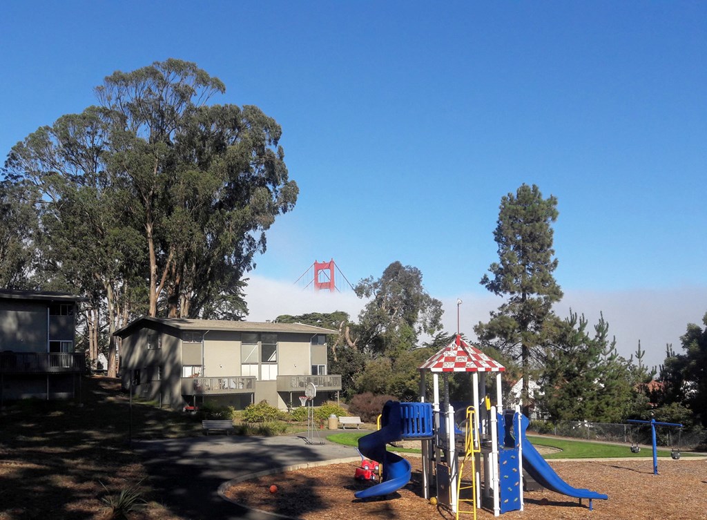 a playground with a view of the golden gate bridge