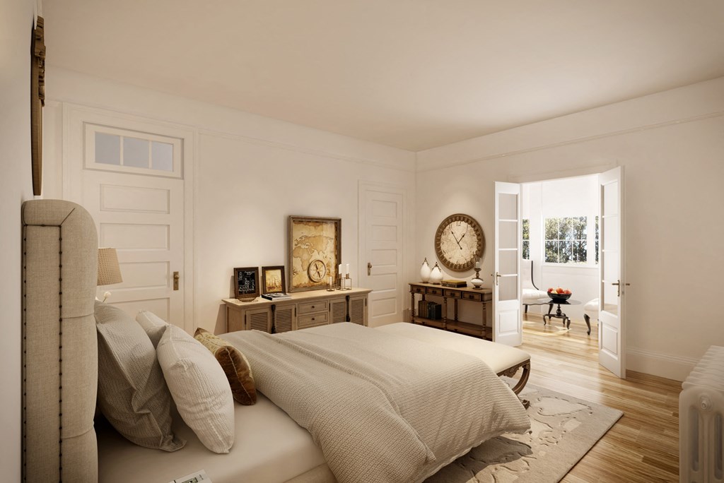 a bedroom with a bed and a large clock on the wall