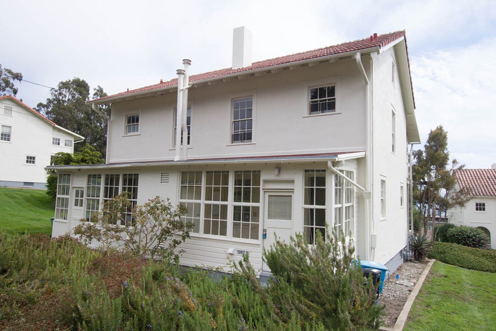 a white house with white windows on the side