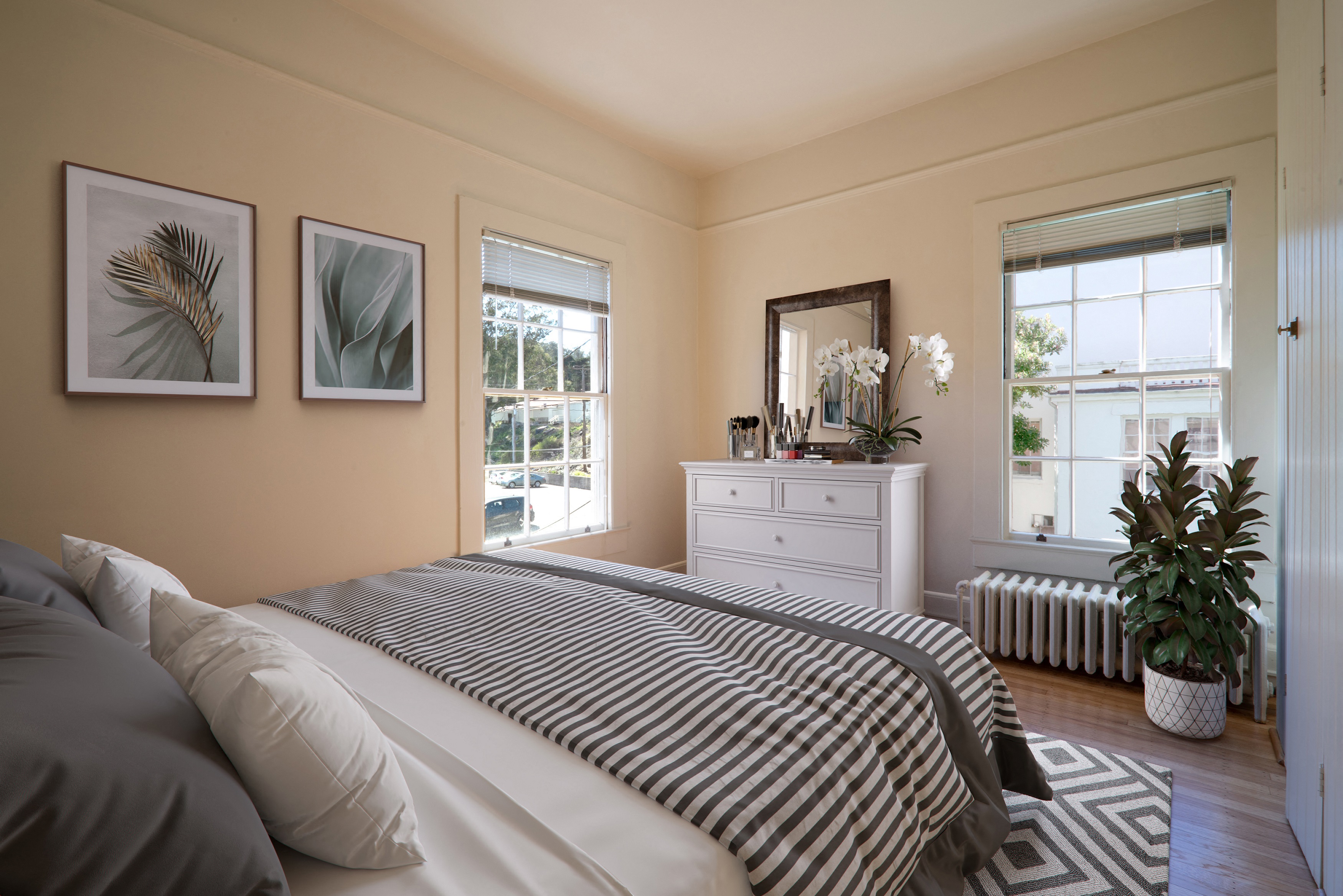 a bedroom with a bed and a dresser and a window