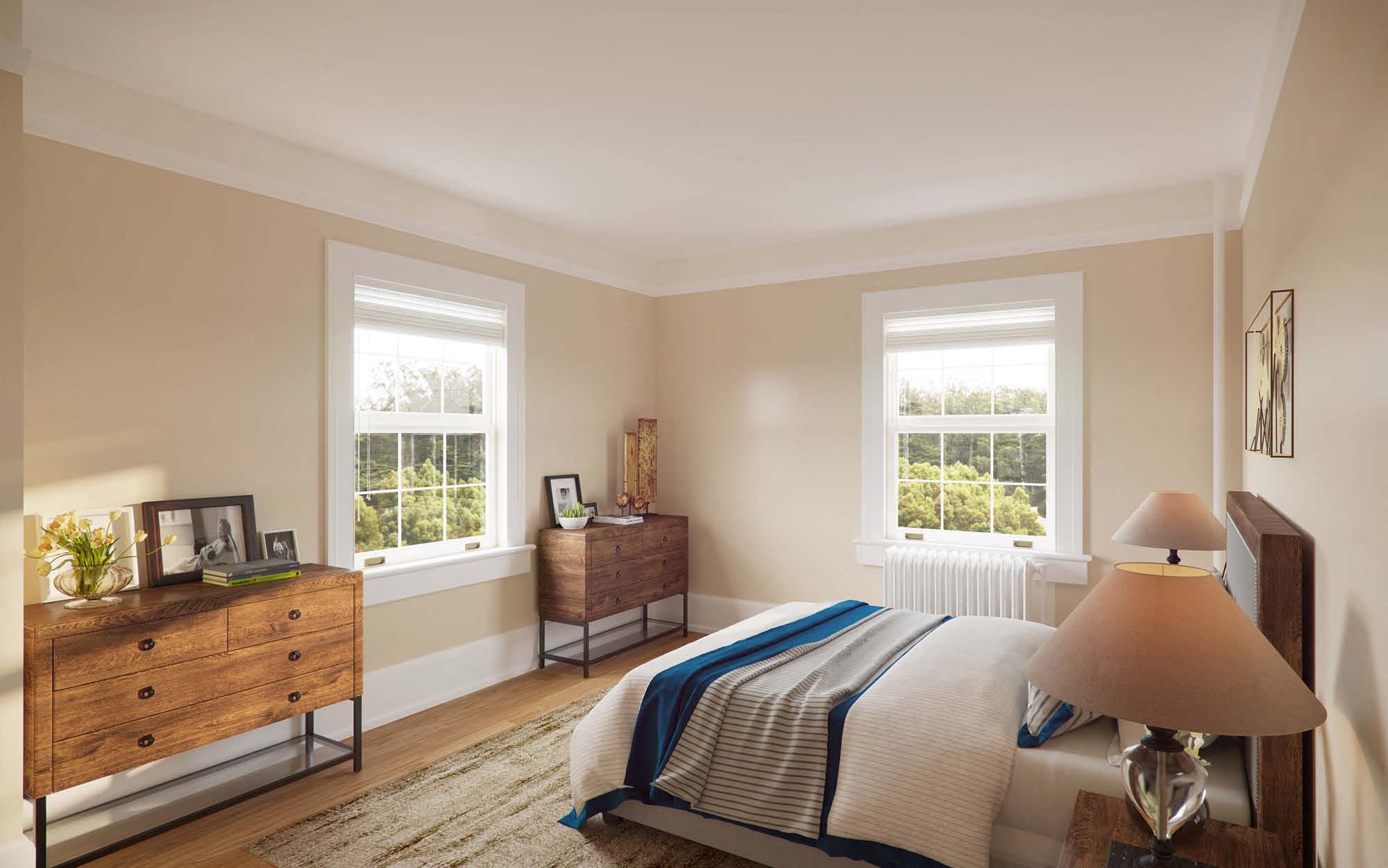 a bedroom with a bed and a dresser and two windows