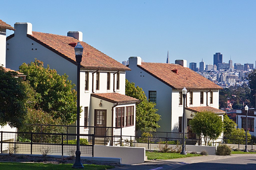 the city in the background of two houses on a hill
