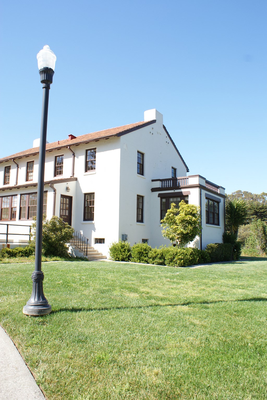 a large white building with a lamp post in front of it