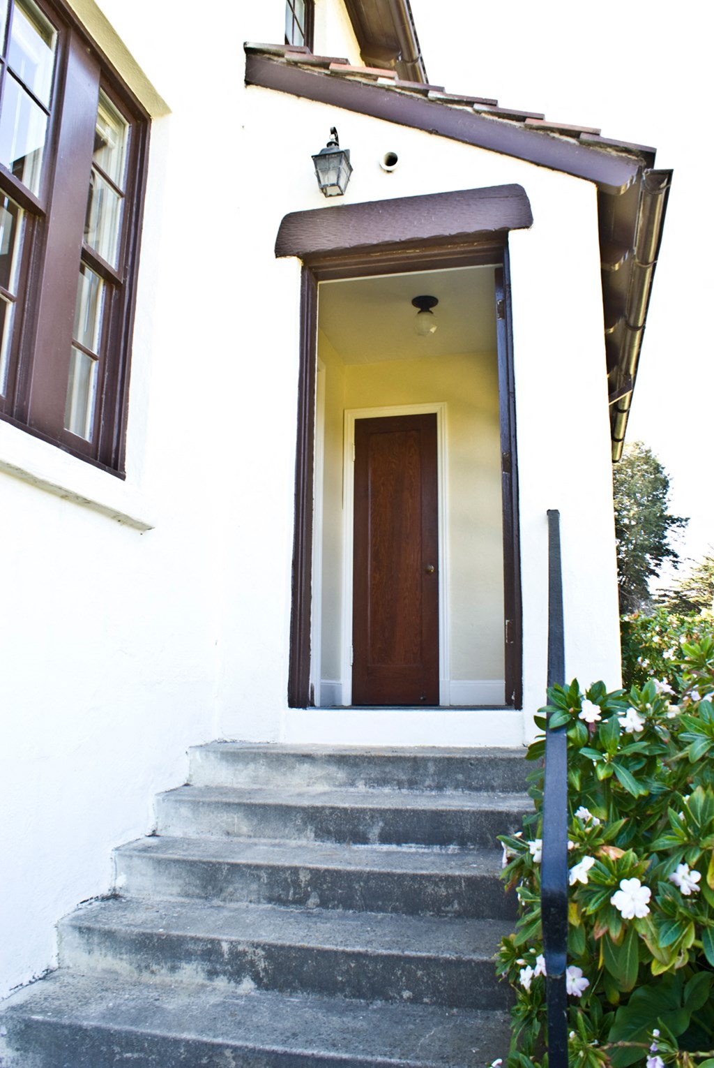a front door of a white house with steps up to it