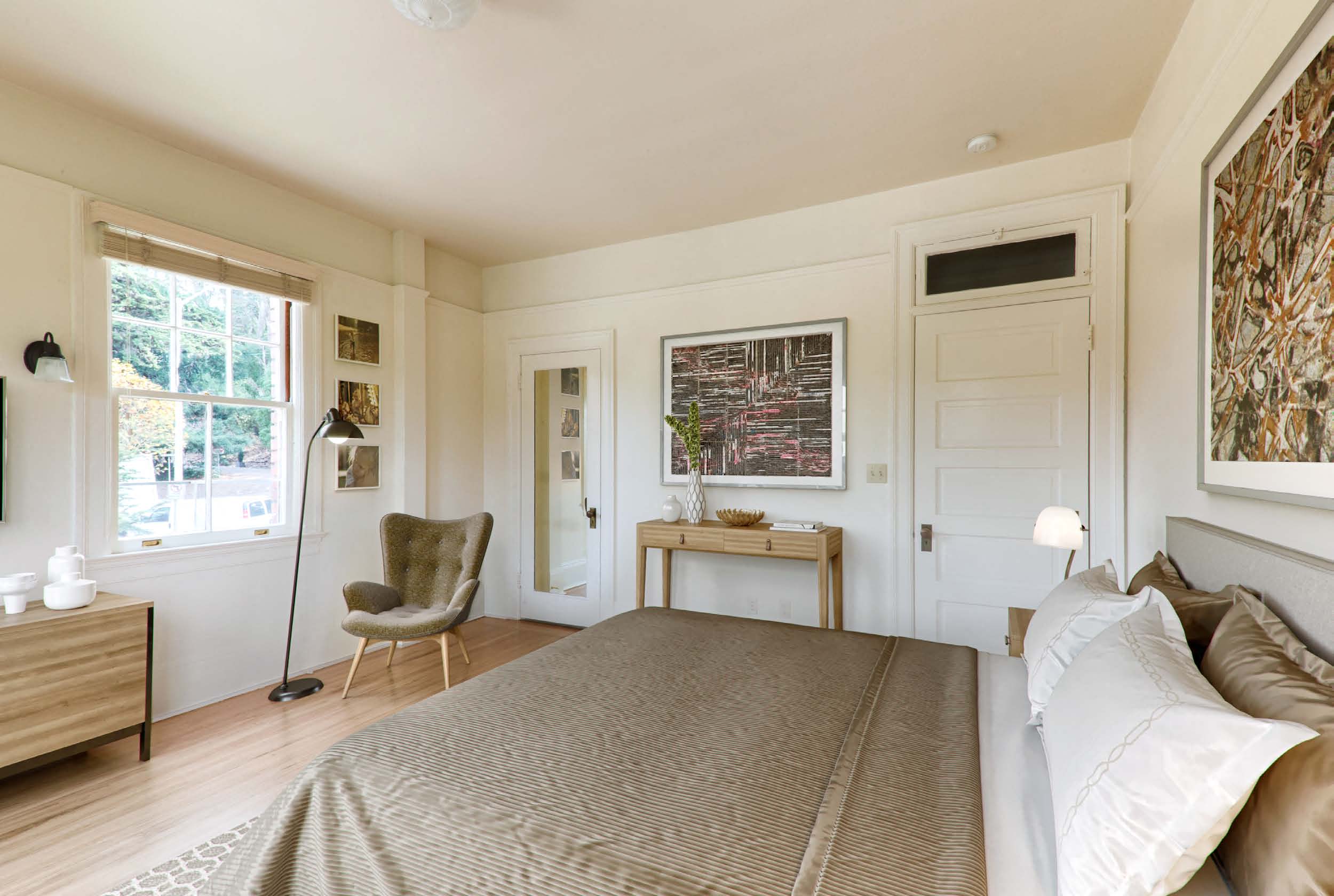 a bedroom with a bed and a chair and a window