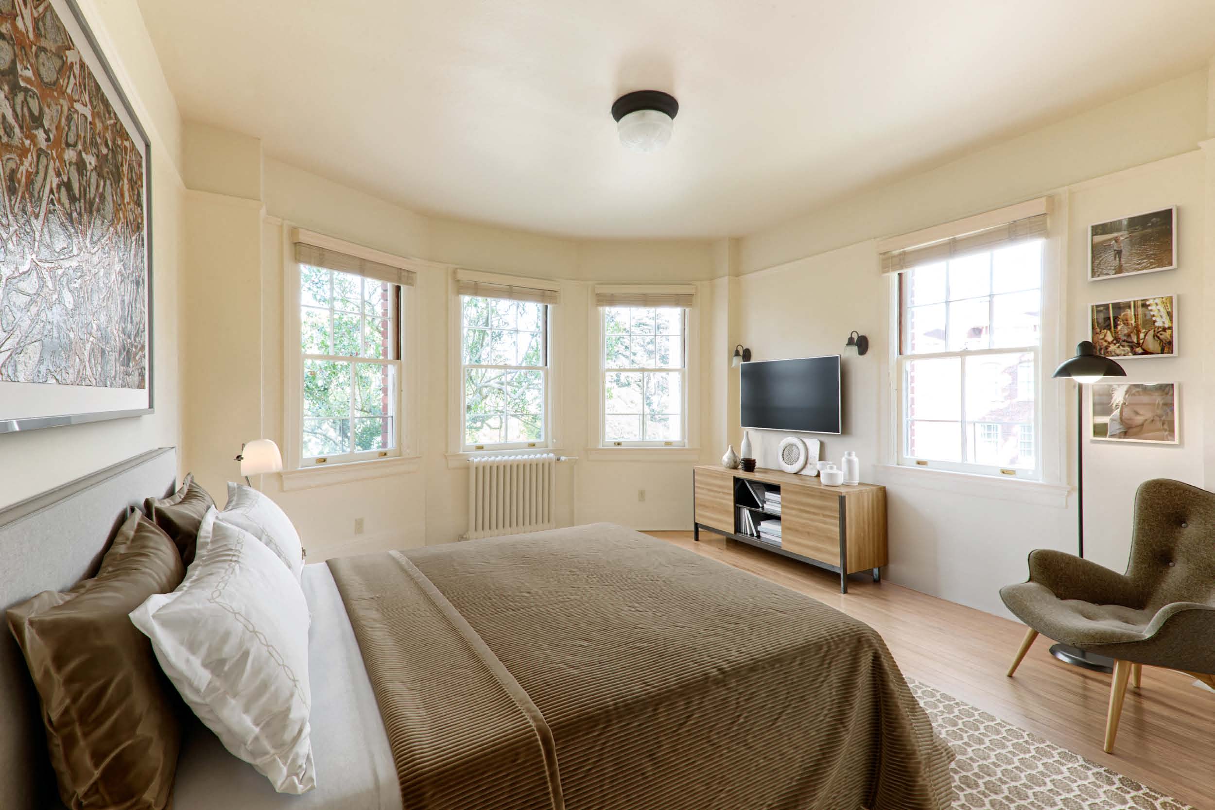 a bedroom with a bed and a tv