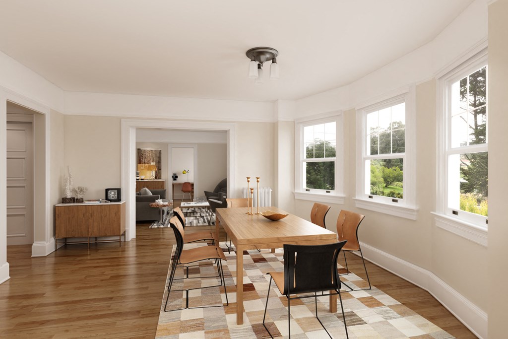 a dining room with a wooden table and chairs