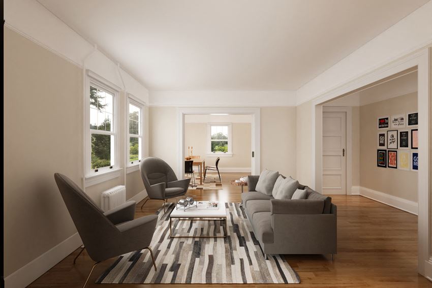 a living room with couches and chairs and a striped rug