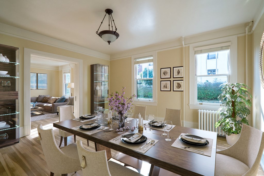 a dining room and living room with a table and chairs