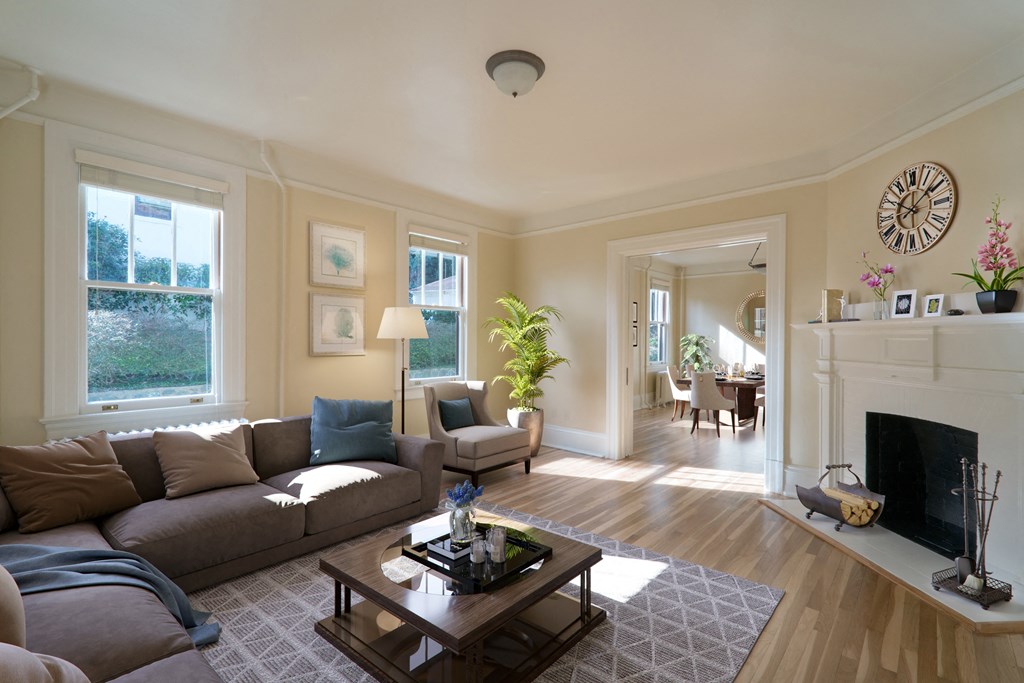 a living room with a couch and a coffee table and a fireplace