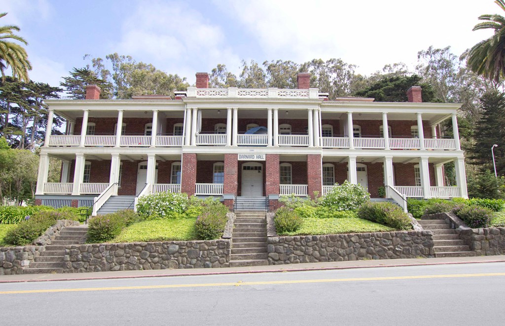 a large antebellum house with steps and a street in front