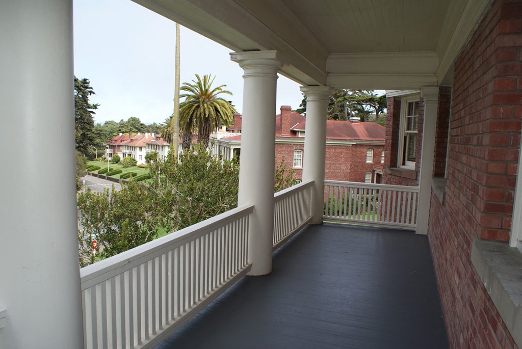 a view of the front porch of a house with columns