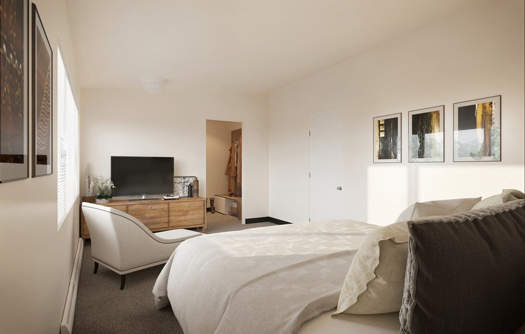 a bedroom with a bed and a chair and a television