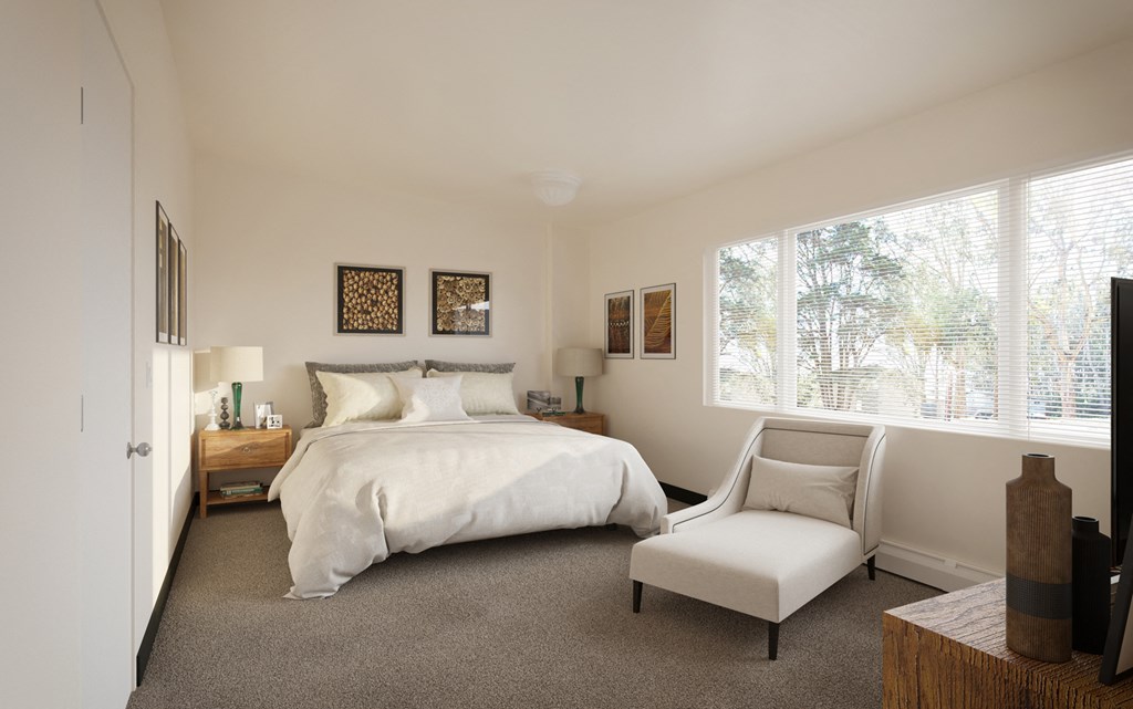 a bedroom with a bed and a chair and a window