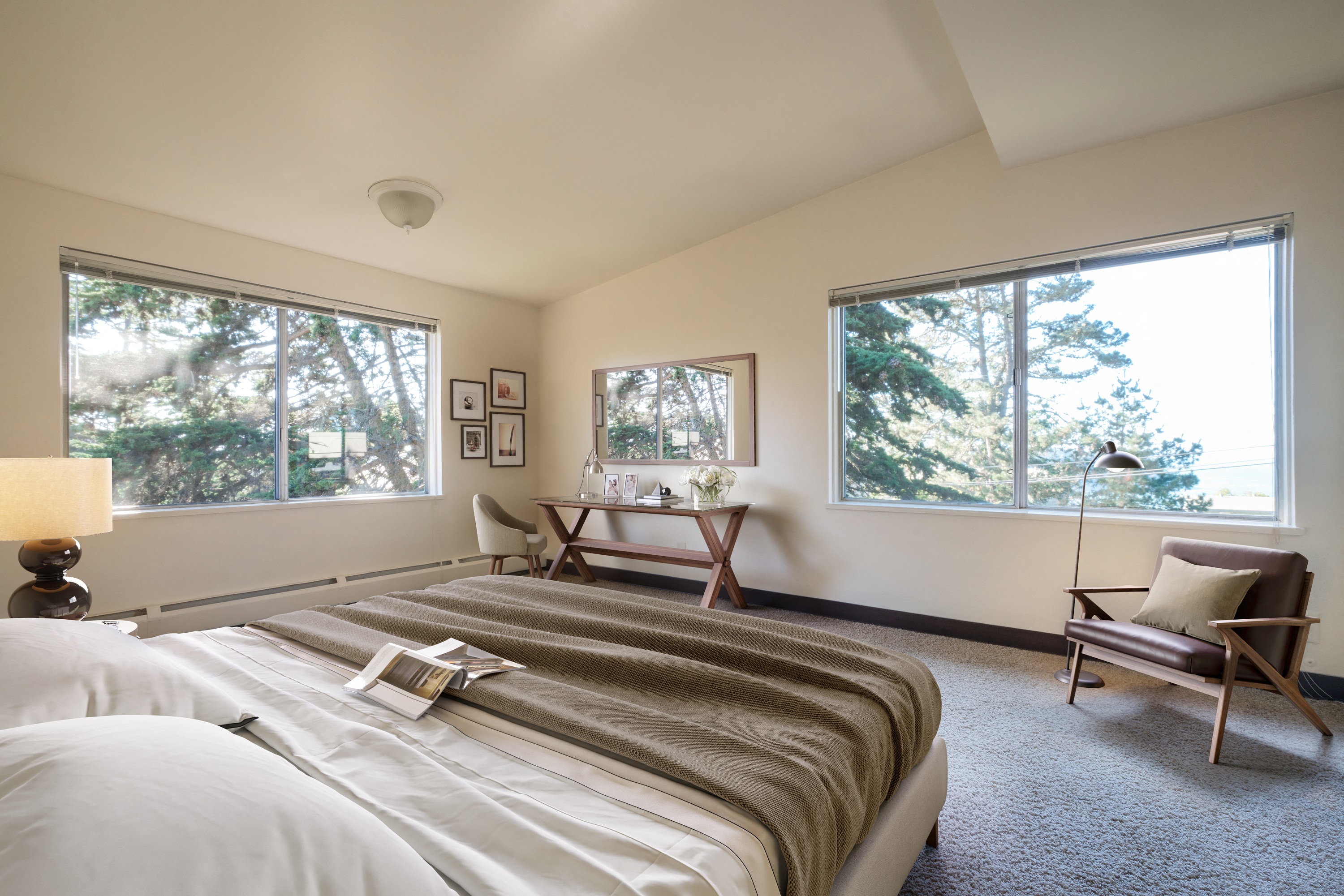 a bedroom with a bed and two windows