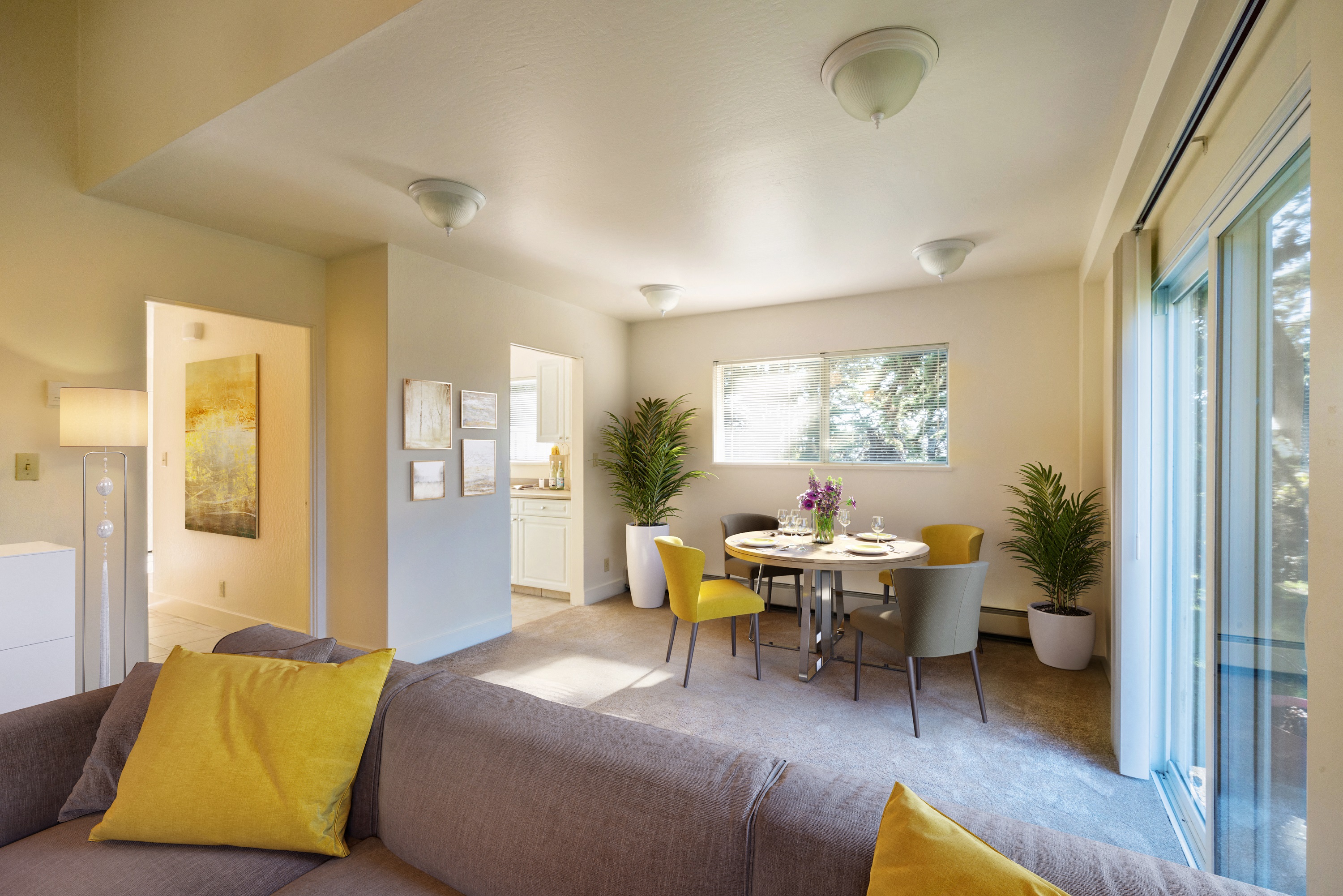 a living room with a couch and a table with chairs