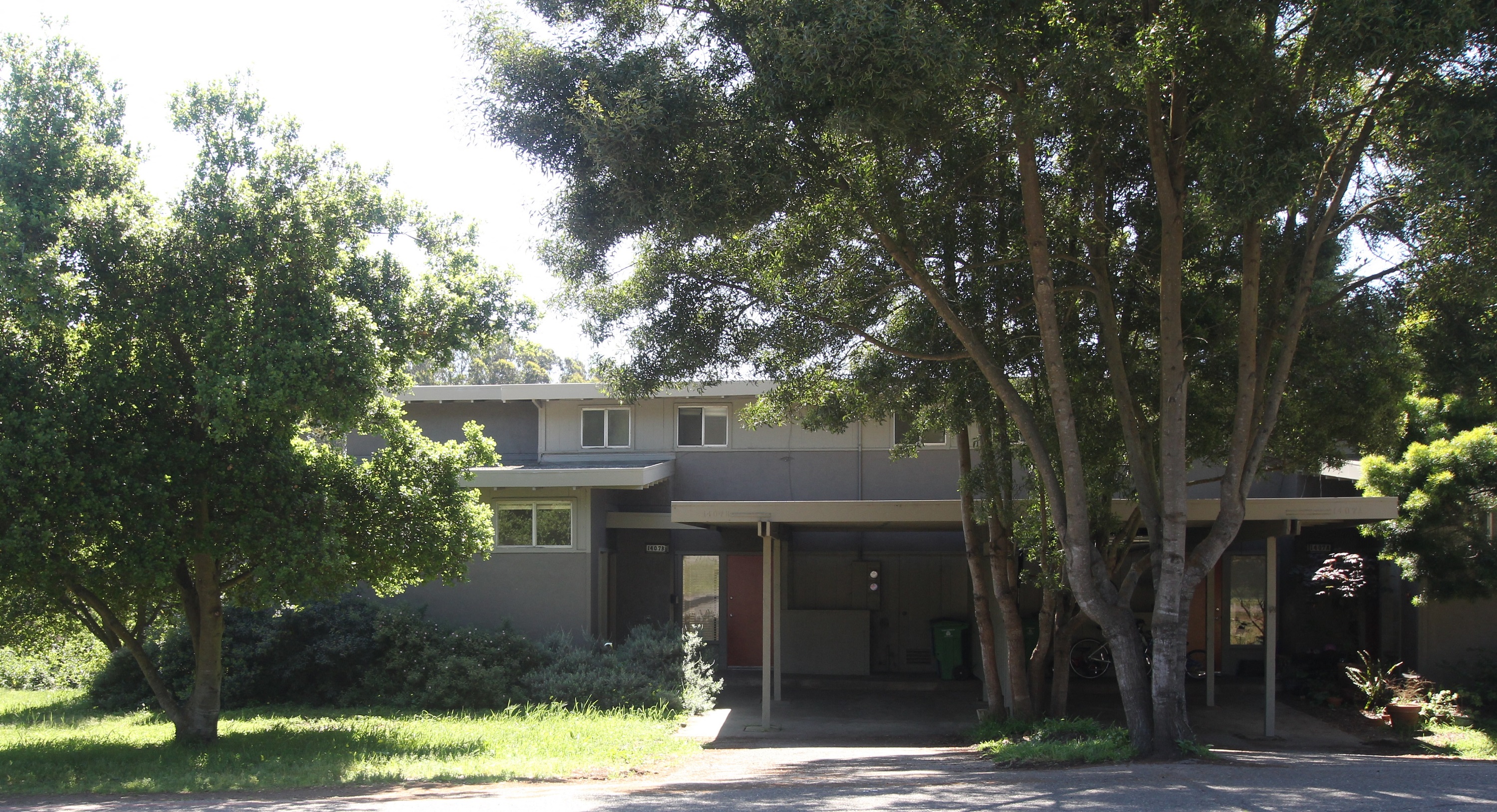 a large house with trees in front of it