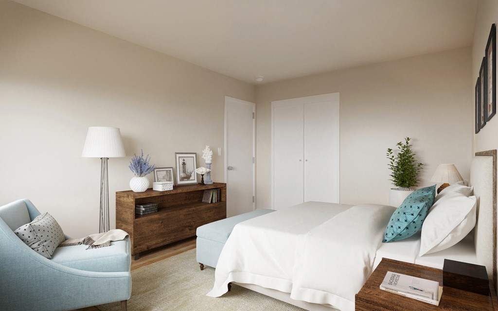 a bedroom with a white bed and a blue chair