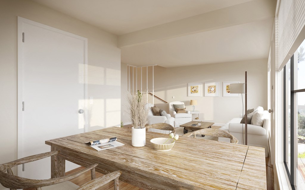 a dining room with a wooden table and a living room