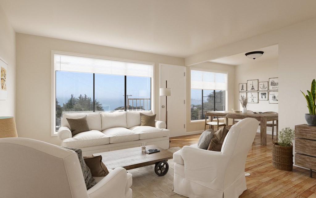 a living room with white furniture and large windows