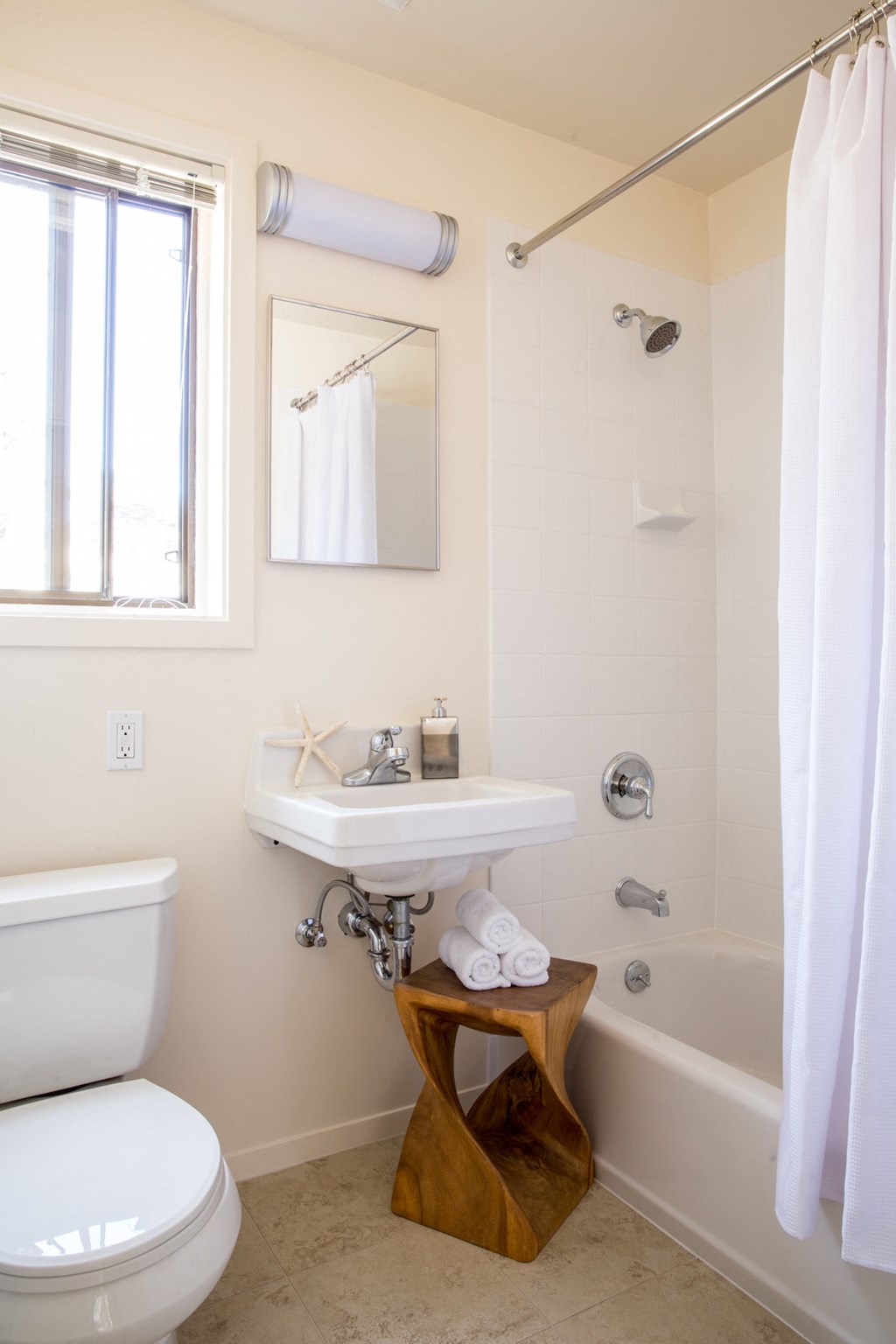 a small bathroom with a toilet sink and tub