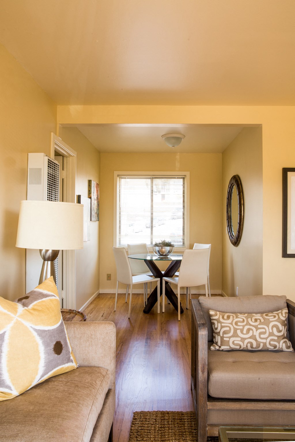 a living room and dining room with a table and chairs
