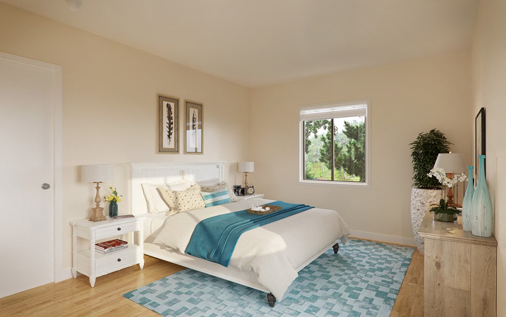 a bedroom with a bed and a blue and white rug