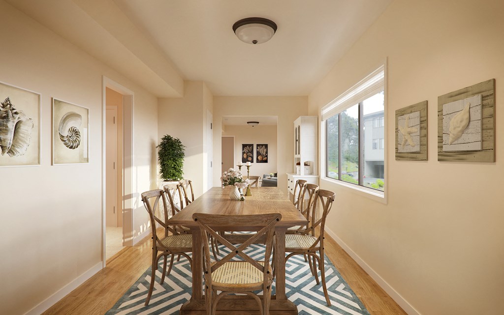 a dining room with a wooden table and chairs