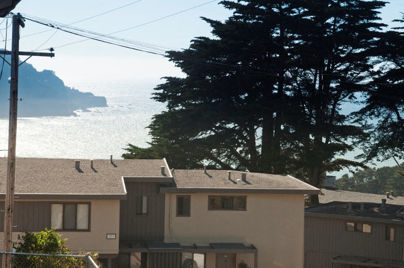 a view of a house with the ocean in the background