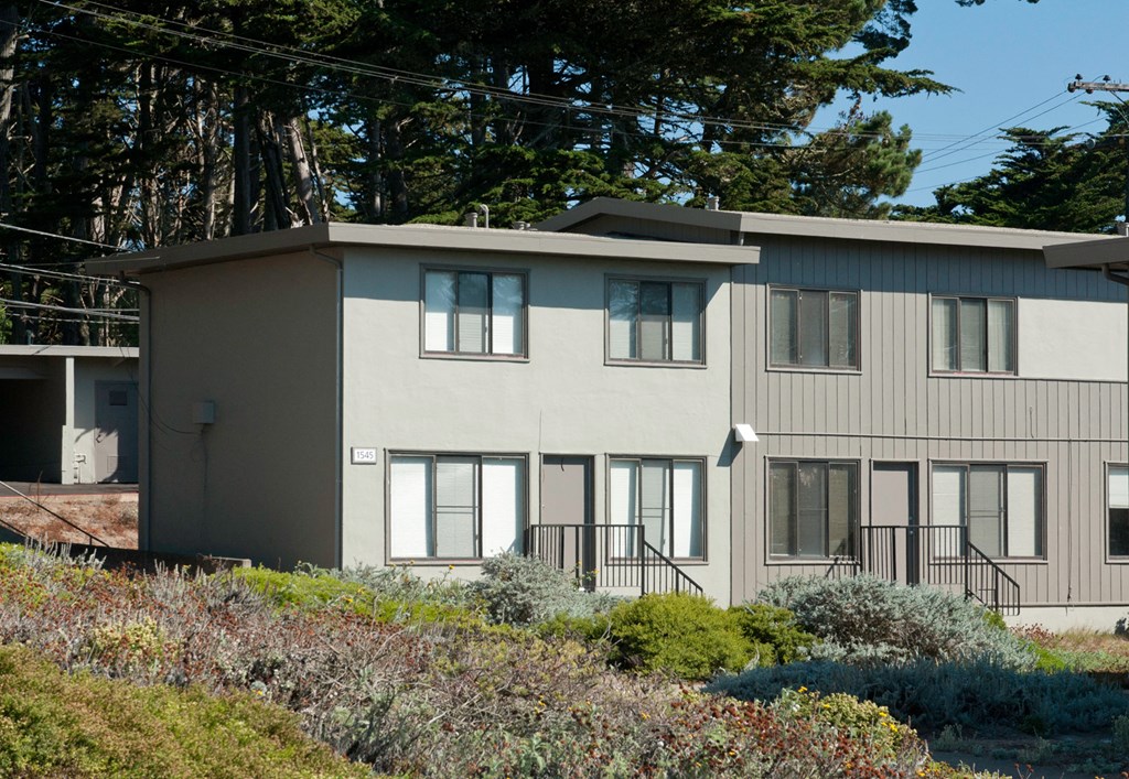 the exterior of a building with trees in the background