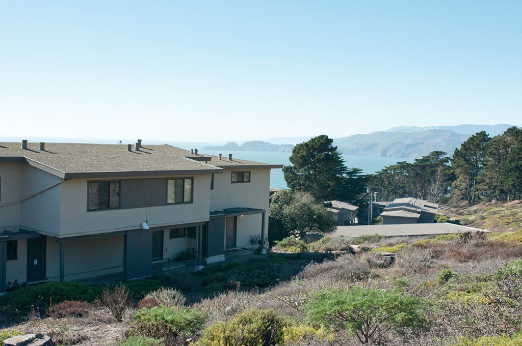 a house on a hill with a view of the ocean