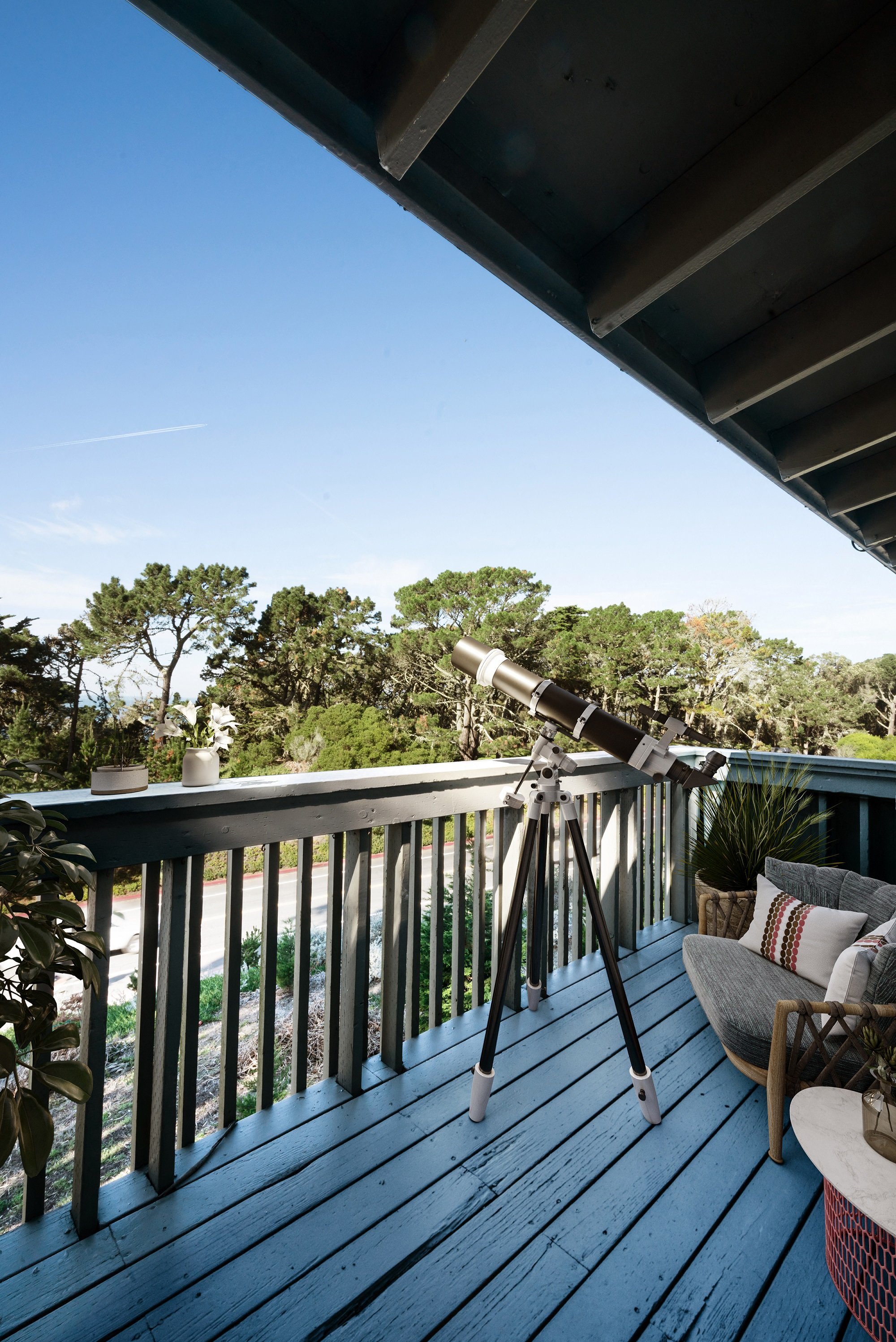 a telescope is set up on the deck of a house