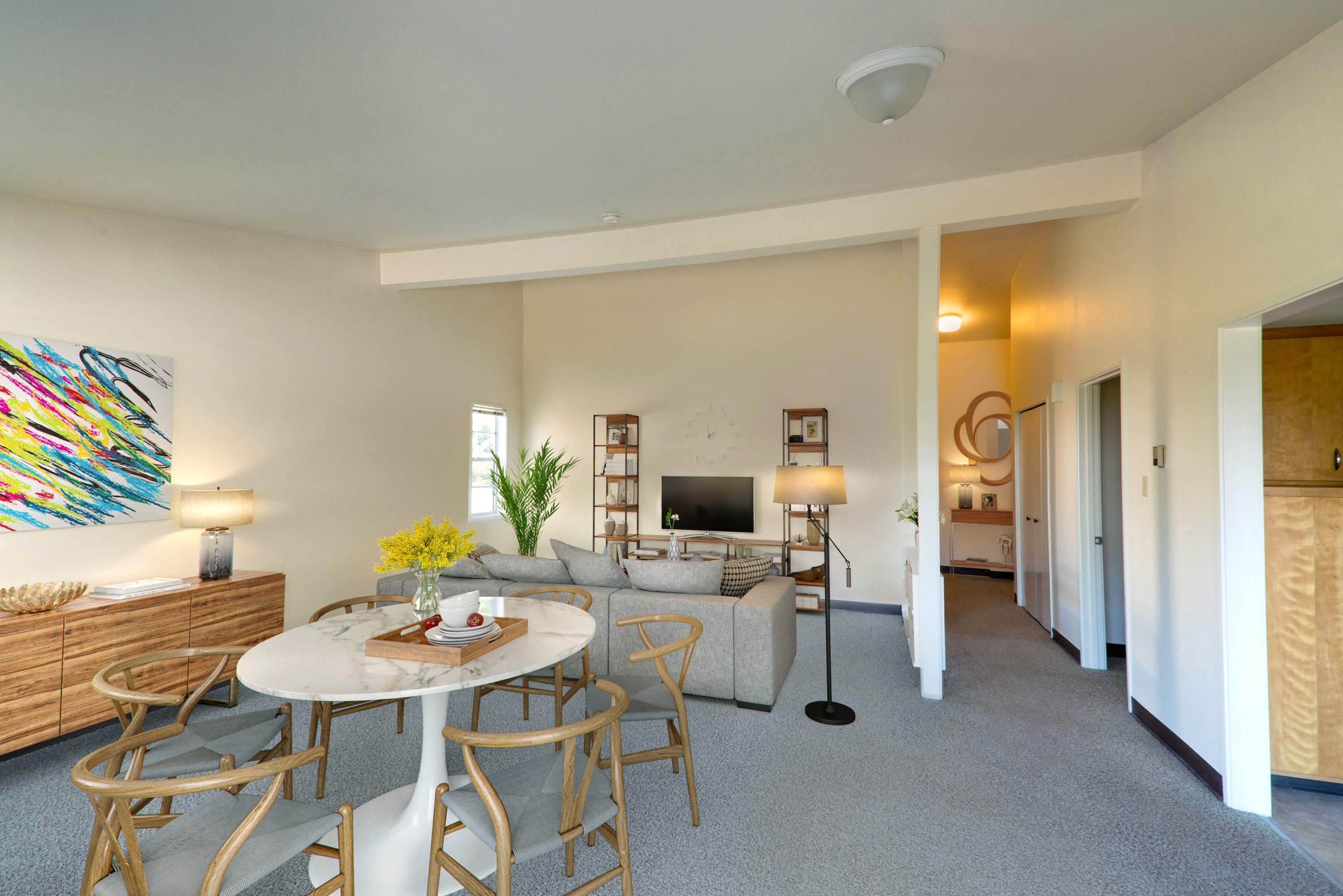 a living room with a round table and chairs and a couch