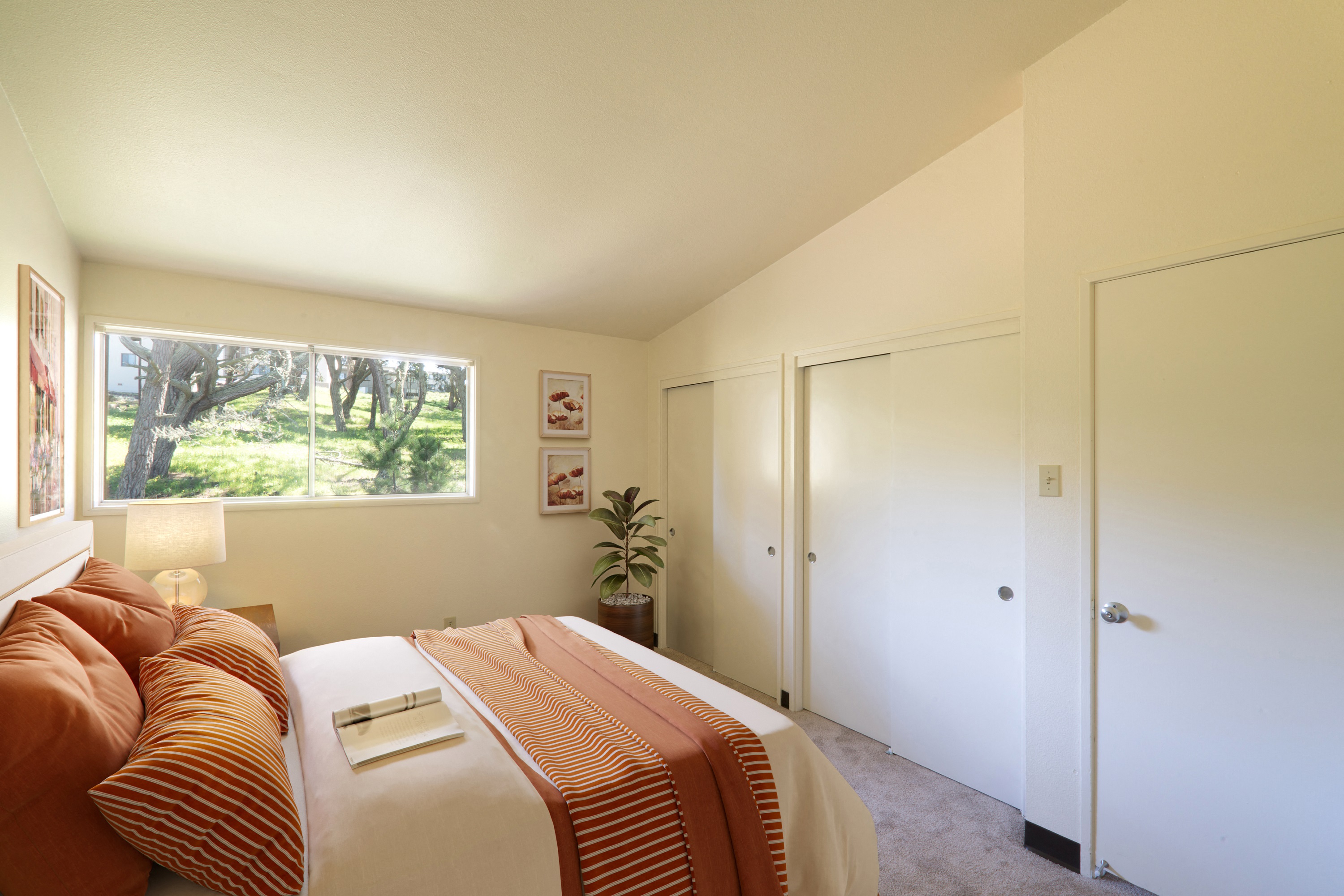 a bedroom with a large bed and a window