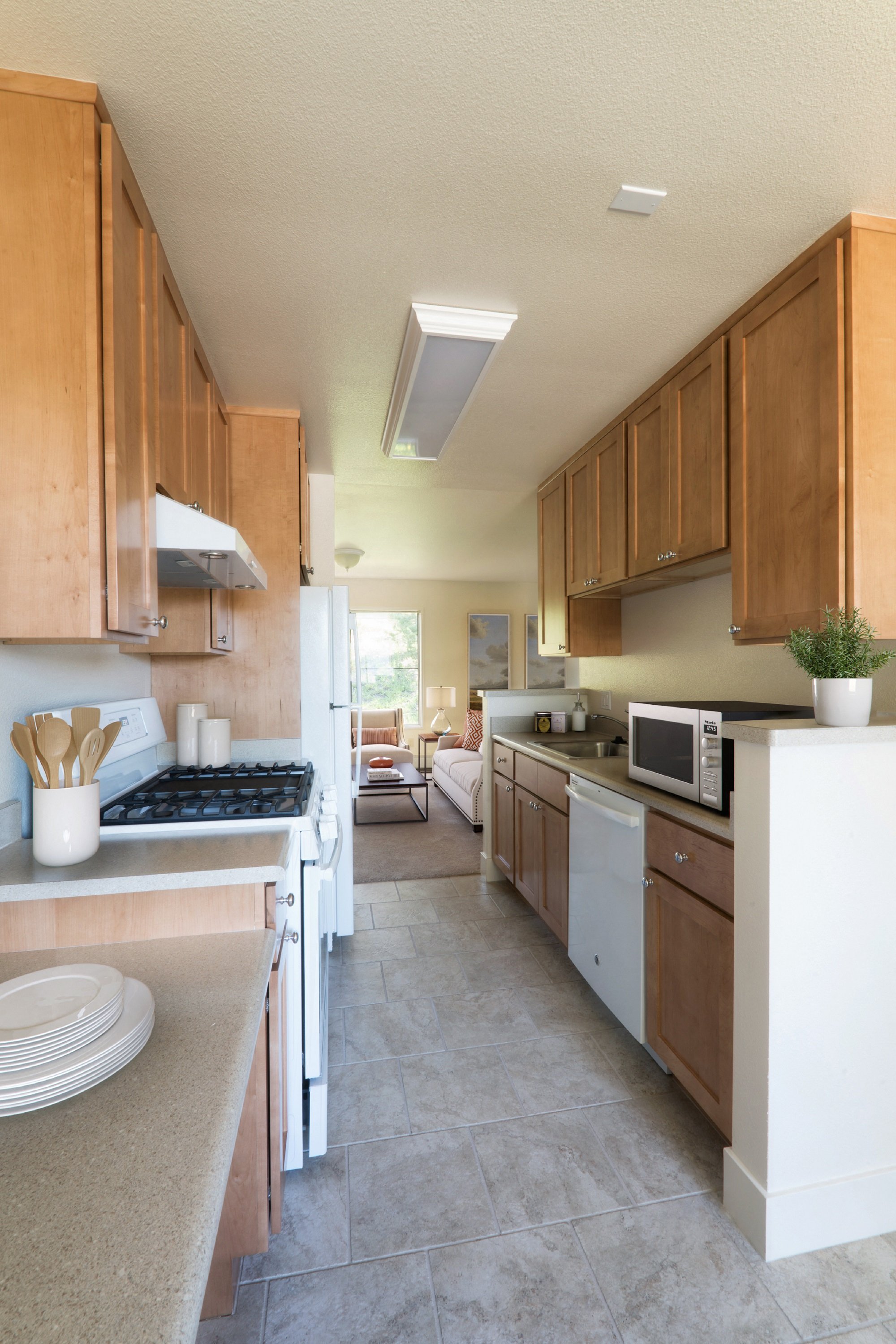 a large kitchen with wooden cabinets and white appliances