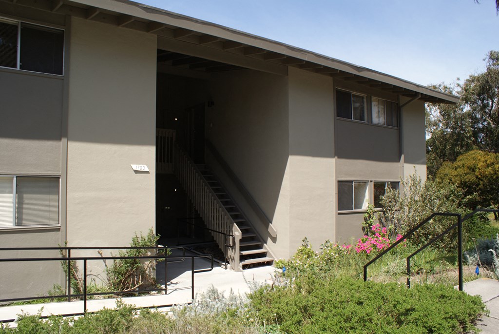 an exterior view of a tan building with stairs