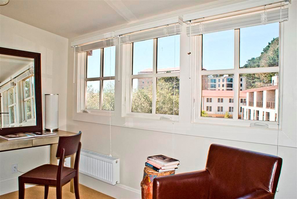 a living room with a chair and a window