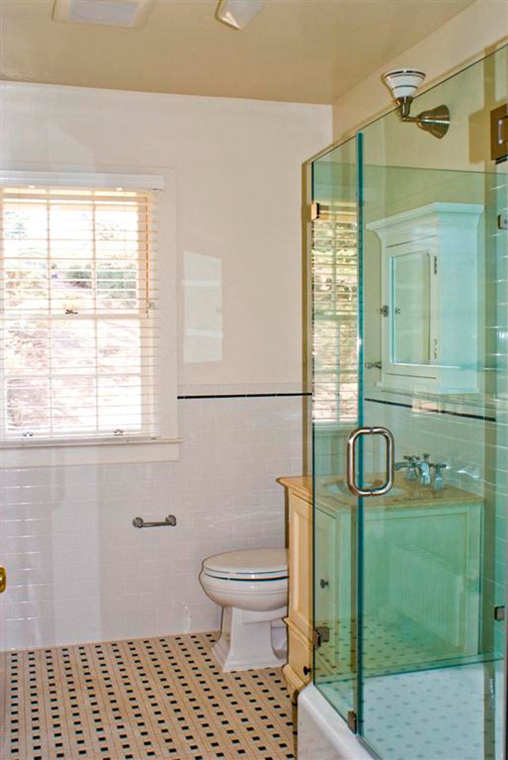 a bathroom with a toilet and a glass shower