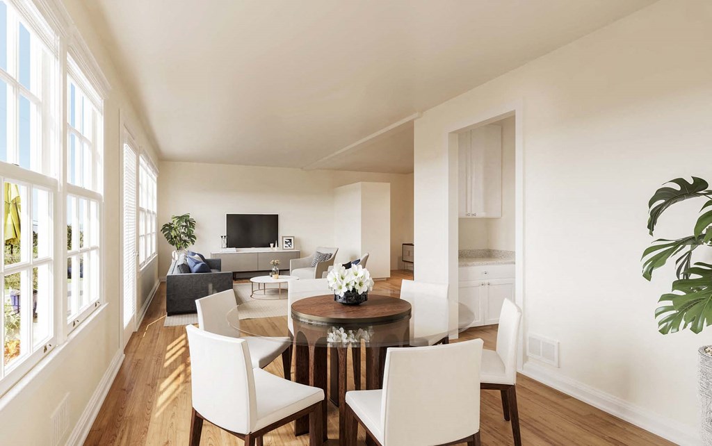 a living room and dining room with a table and chairs