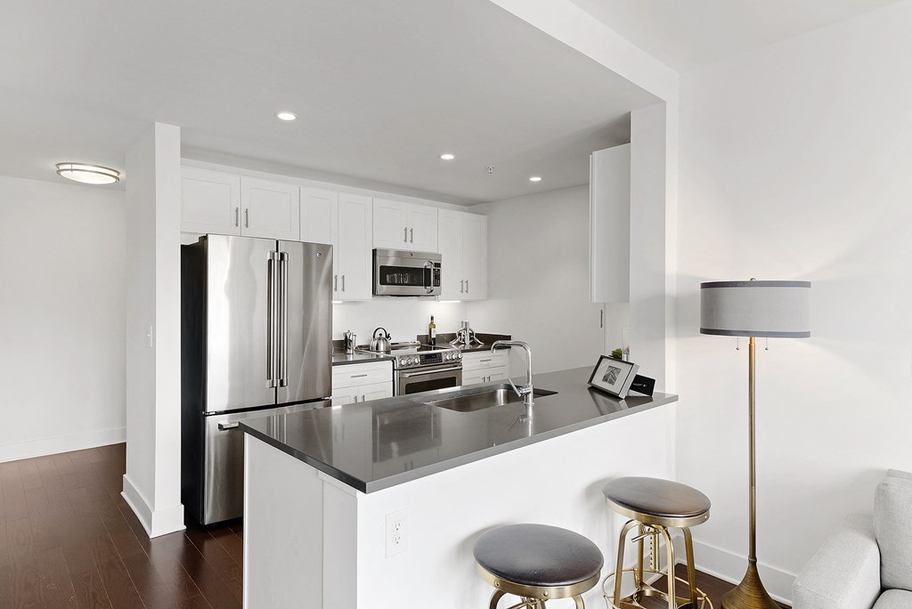 a kitchen with a counter top and a refrigerator