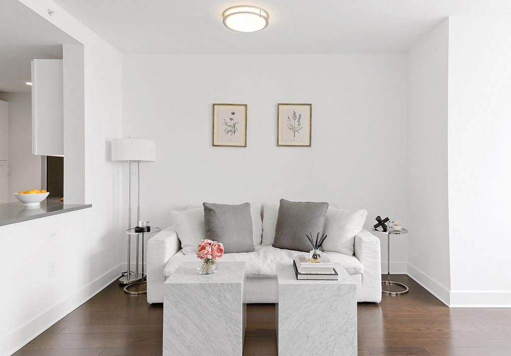 a living room with a white couch and a coffee table