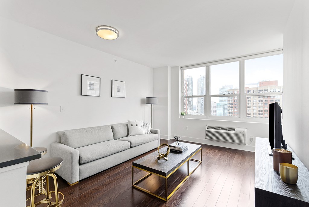 Living room with white couch1 at 65 Bay Street, Jersey City, NJ