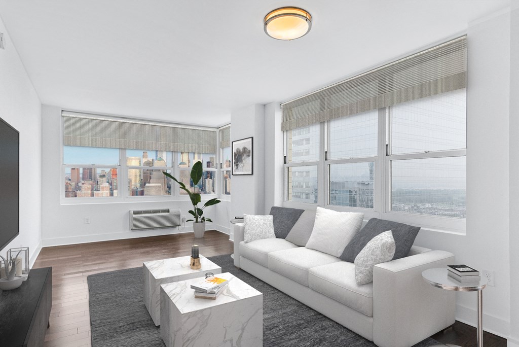 Living room with white couch and table with ceiling light at 65 Bay Street, Jersey City, New Jersey