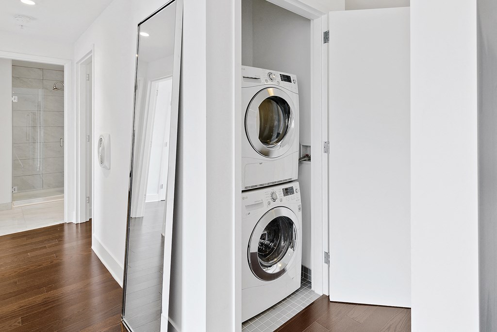a front loading washer and dryer in a white laundry room