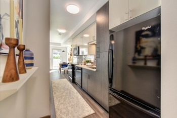 Kitchen Alley Kitchen Alley with Hardwood Inspired Floor, Rug, Wood Cabinents and Refrigerator - Photo Gallery 3
