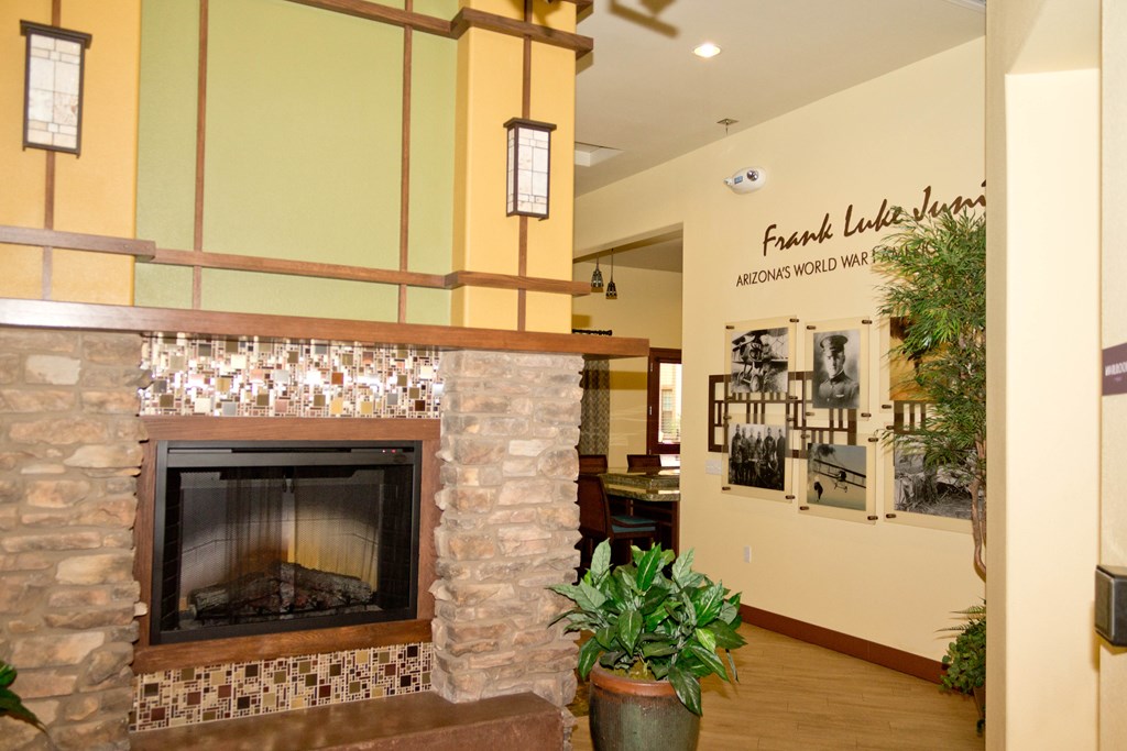 a living room with a fireplace and a wall with a sign on it