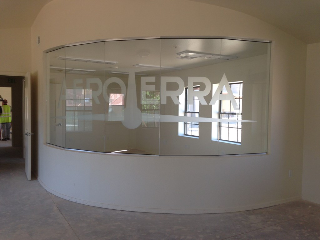 a curved glass wall with the wordcorpora on it