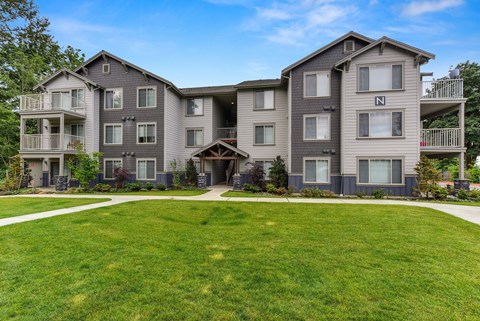 Front of Avaya Trails with Grass, Walking Path, Gray Apartment Exteriors